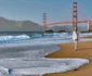 A person walks along the sandy beach, with waves rolling in and the Golden Gate Bridge in the background under a clear sky.