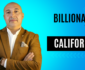 Man in a brown jacket with arms crossed stands next to text reading "Billionaire Tax California" on a blue background.